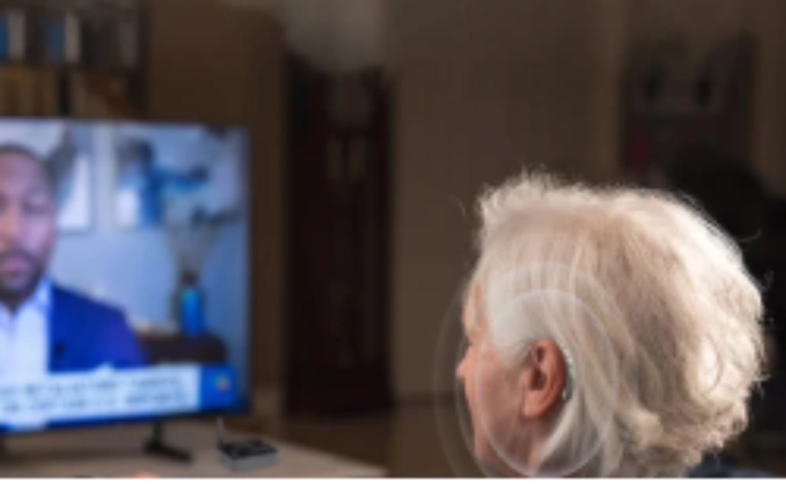 Person watching TV while using hearing aids